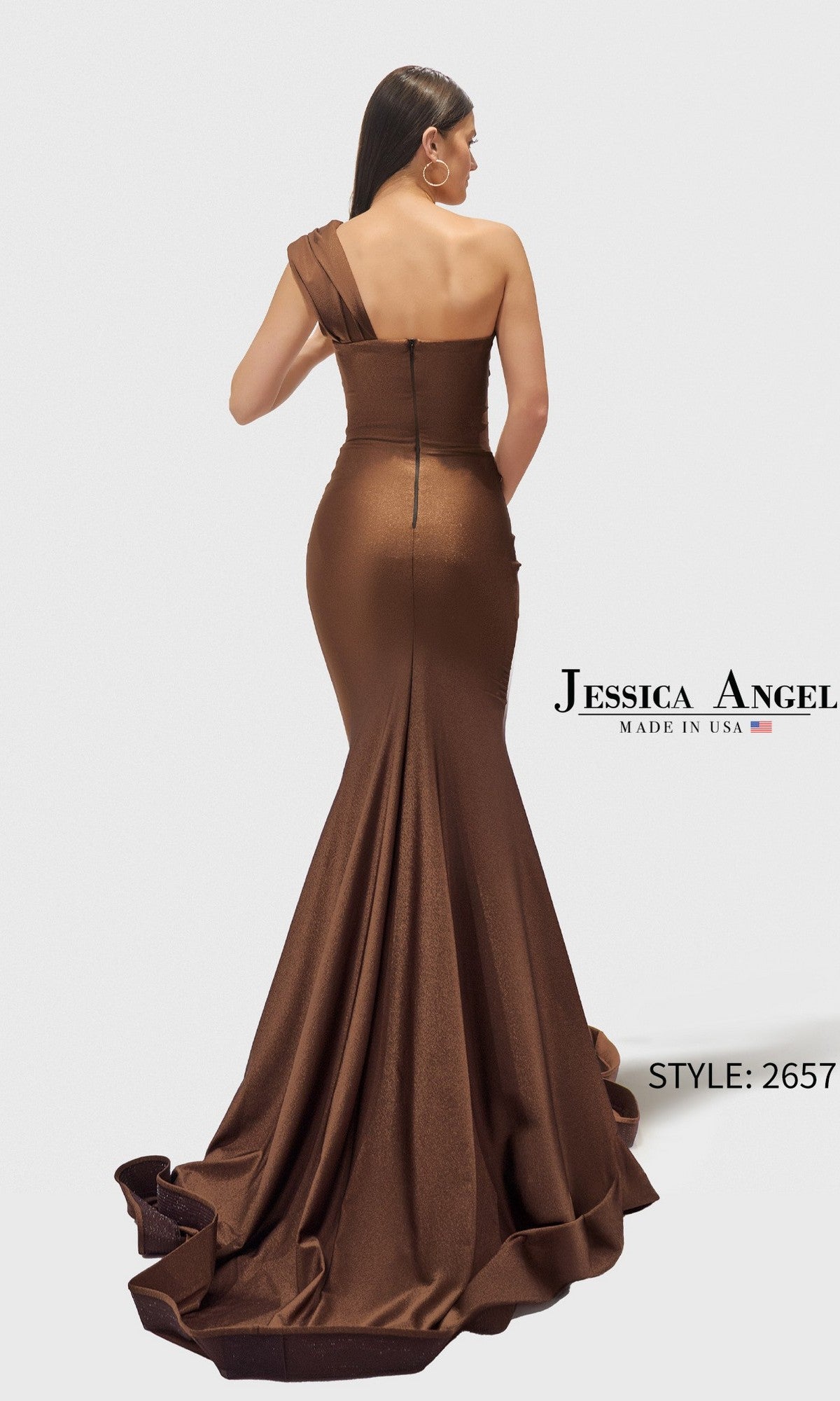 A woman models the Jessica Angel 2657 long prom dress: a brown, one-shoulder, floor-length mermaid gown with a long train, shown from the back. Text reads